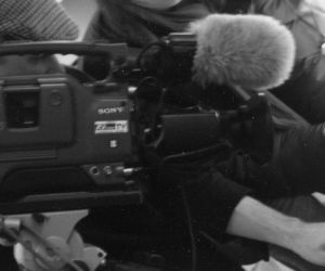 A big old DV camera pointing at an old typewriter